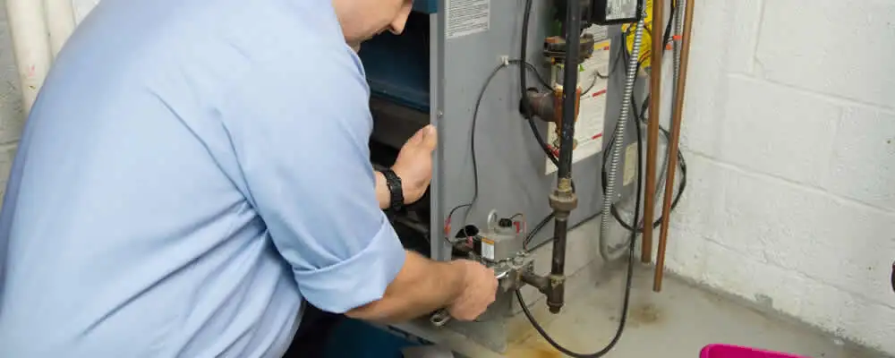 Furnace repair technician inspecting and servicing a home heating system in Billings, MT
