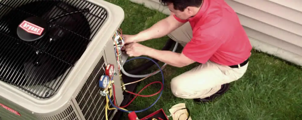 HVAC technician servicing an outdoor air conditioner unit in Billings, MT