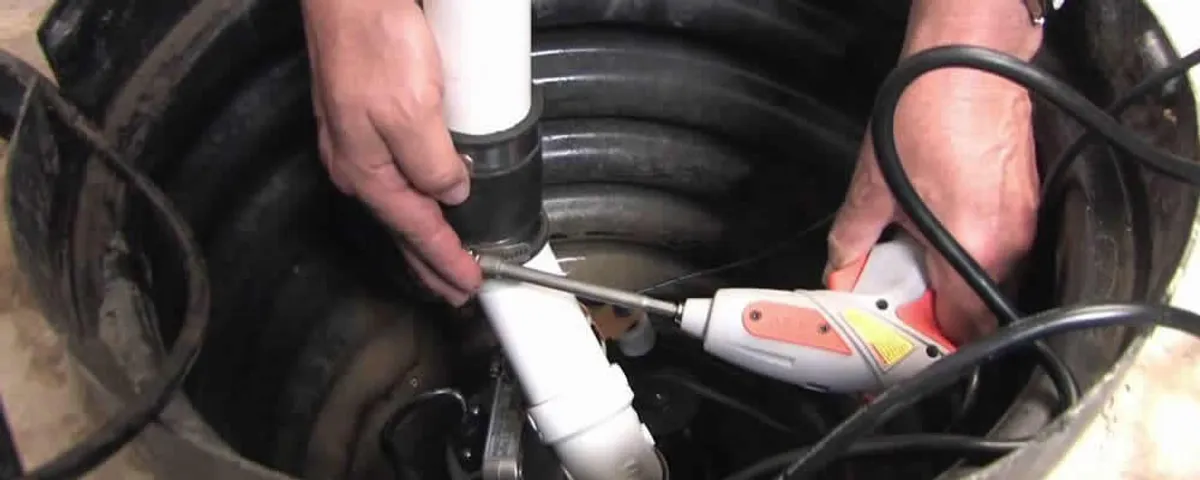 Sump pump installation technician connecting PVC discharge piping in Billings, MT