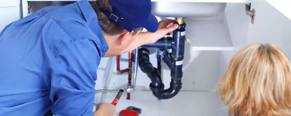 Plumber repairing under-sink drain pipes and fittings in Billings, MT